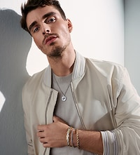 Shop BOSS New Arrivals on Goldsmiths. Banner showing model wearing mixed jewellery image