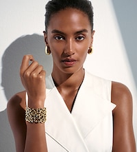 Shop BOSS Ladies Jewellery on Goldsmiths. Banner showing model wearing mixed jewellery image