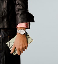 Baume and Mercier male model wearing leather jacket and watch. Tap to shop mens watches image