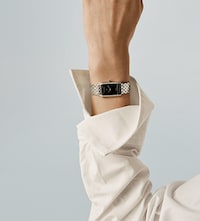 Baume and Mercier model wearing white shirt and watch. Tap to shop new arrivals from baume and mercier image