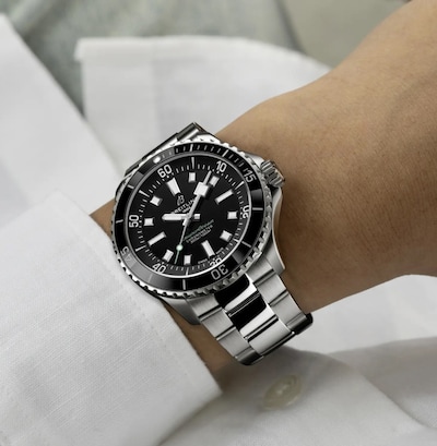 Image of a men wearing Breitling Superocean 42mm UK Limited Edition Mens Watch Black Dial Stainless Steel Bracelet - Tap to Collection image
