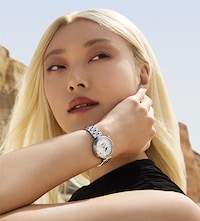 Female model wearing Tissot watch. Tap to Shop Ladies Watches image
