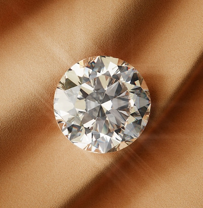 Image of signature diamond on sandy background - tap to shop all goldsmiths signature diamond collection image