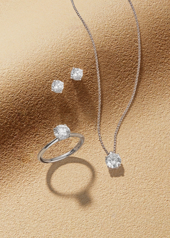 Goldsmiths Signature Diamond White Gold Jewellery on sandy background