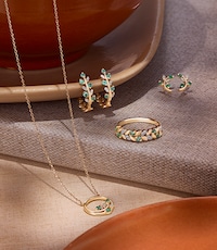 Image of mixed gemstone jewelery on terracotta background. tap to shop gemstone jewellery image