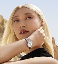 Female model wearing Tissot watch. Tap to Shop Ladies Watches image