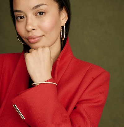 An image of lady wearing Ted Baker earrings and bracelet. image