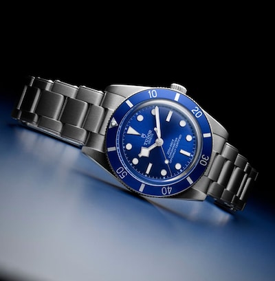 Tudor Black bay watch in blue on black background. Tap to shop image