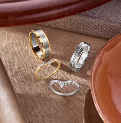 Image of wedding rings on cream background. tap to shop all wedding rings image